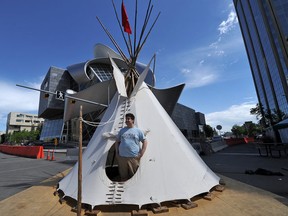 Nathanael Daniels mans the Otinikan Leadership Academy Out of School Program for Aboriginal Art Students Tipi in front of the AGA at the Works Festival site in Churchill Square in Edmonton, Ab on Monday, June 25, 2012. ( Photo by John Lucas/Edmonton Journal)