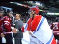 Russian captain Nail Yakupov congratulates his Canadian counterpart Jonathan Huberdeau while draped in the flag of Yaroslavl Lokomotiv after the conclusion of the Canada-Russia Challenge.