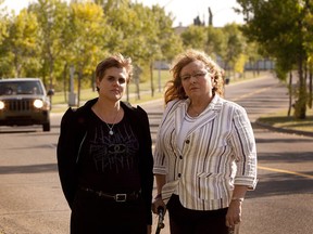 Bev Szucs (left) and Teresa Hebert in front of 44th Avenue, where an elderly man was hit last fall. There have been about seven serious accidents on this stretch of road since 2001. (Greg Southam/ Edmonton Journal)