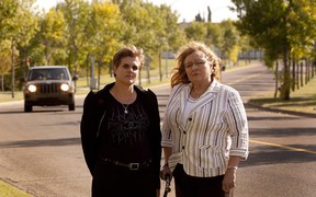 Bev Szucs (left) and Teresa Hebert in front of 44th Avenue, where an elderly man was hit last fall. There have been about seven serious accidents on this stretch of road since 2001. (Greg Southam/ Edmonton Journal)