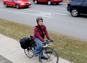 Chris Chan stands for a photo near 76 Avenue and 106 Street, where a bike lane suddenly turns into a shared use lane. Photo by Larry Wong/Edmonton Journal)