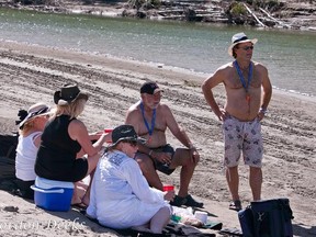 A group friends enjoy an afternoon at Big Island, a sandy beach on the river only accessible by boat. Photo by Gord Deeks.