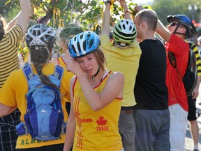 Cyclists grieve for 21-year-old Isaac Kornelsen, caught between a parked pickup and a cement truck while biking on Whyte Avenue in August 2012. Photo by Shaughn Butts, Edmonton Journal.