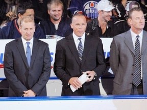 Former coach Ralph Krueger's assistant coaches Kelly Buchberger (centre) and Steve Smith (right) have two other things in common -- both were terrific late round draft choices by the Edmonton Oilers, and both contributed to multiple Stanley Cup winning Oiler squads.