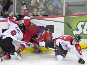 The mayhem started early as Russian captain Nail Yakupov got squished between Canadian bruisers Mark McNeill and Adam Lowry in the game's first minute.
Photograph by: DARRYL DYCK , THE CANADIAN PRESS