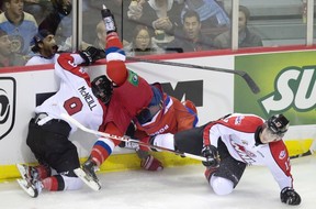 The mayhem started early as Russian captain Nail Yakupov got squished between Canadian bruisers Mark McNeill and Adam Lowry in the game's first minute.
Photograph by: DARRYL DYCK , THE CANADIAN PRESS
