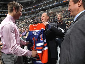 Edmonton Oilers chief scout presents draft pick Mitch Moroz with a jersey at the 2012 NHL Draft (Photo: Bruce Bennett/Getty Images)