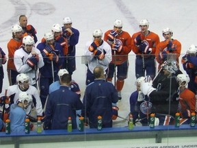 Ralph Krueger (front and centre, with bald spot) has the complete attention of his team. (Photo: Bruce McCurdy)