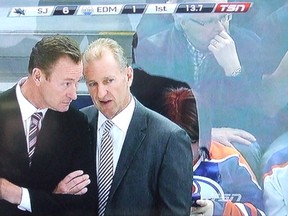 Insert your own caption here. I'd add a speech bubble, but the ticker above Oilers coaches Steve Smith and Ralph Krueger already says enough.