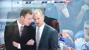 Insert your own caption here. I'd add a speech bubble, but the ticker above Oilers coaches Steve Smith and Ralph Krueger already says enough.