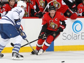 Daniel Alfredsson #11 of the Ottawa Senators makes a pass past a defending Dion Phaneuf #3 of the Toronto Maple Leafs, during an NHL game at Scotiabank Place on February 23, 2013 in Ottawa, Ontario, Canada. (Photo by Jana Chytilova/Freestyle Photography/Getty Images)