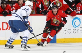 Daniel Alfredsson #11 of the Ottawa Senators makes a pass past a defending Dion Phaneuf #3 of the Toronto Maple Leafs, during an NHL game at Scotiabank Place on February 23, 2013 in Ottawa, Ontario, Canada. (Photo by Jana Chytilova/Freestyle Photography/Getty Images)