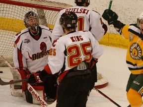 Alberta Golden Bears' Drew Nichol, right, celebrates a goal scored by teammate Ian Barteaux (not pictured) on Calgary Dinos goalie Dustin Butler during their Canada West men's hockey semifinal Game 2 at Clare Drake Arena on Feb. 23, 2013 in Edmonton. Photo by Greg Southam/Edmonton Journal