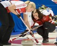 Team Canada skip Heather Nedohin, right, and Laine Peters guide in a rock during curling action against New Brunswick at the Scotties Tournament of Hearts in Kingston, Ont., on February 16, 2013. THE CANADIAN PRESS/Ryan Remiorz