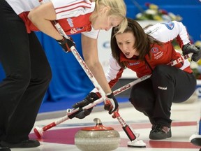 Team Canada skip Heather Nedohin, right, and Laine Peters guide in a rock during curling action against New Brunswick at the Scotties Tournament of Hearts in Kingston, Ont., on February 16, 2013. THE CANADIAN PRESS/Ryan Remiorz