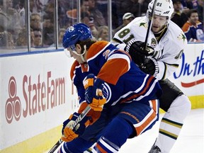 Dallas Stars' Tomas Vincour (81) and Edmonton Oilers' Jeff Petry (2) battle in the corner during first period NHL hockey action in Edmonton, Alberta, on Tuesday Feb. 12, 2013. (AP Photo/The Canadian Press, Jason Franson)