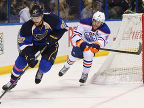Alex Pietrangelo of the St. Louis Blues, left, controls the puck against Taylor Hall of the Edmonton Oilers at the Scottrade Center on March 1, 2013 in St. Louis, Missouri.  Photo by Dilip Vishwanat, Getty Images