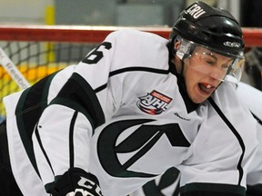 Sherwood Park Crusaders (white) #6 Marshall Donald bowls over Fort McMurray Oil Barons #16 Adam Durkee during Alberta Junior Hockey League action at Sherwood Park Arena, December 5, 2012. Photo by Ed Kaiser, Edmonton Journal