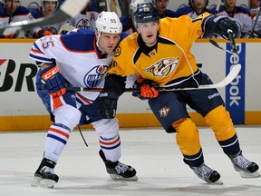 Ben Eager, at left March 8, 2013,tangling with the Nashville Predators' Bobby Butler, has been put on waivers by the Edmonton Oilers. Photo by Frederick Breedon, Getty Images
