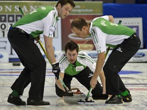 Larry Wong/Edmonton Journal
Saskatchewan skip Brock Virtue delivers a rock as teammates DJ Kidby, left, and Chris Schille sweep during Saturday afternoon's game against Prince Edward Island's Eddie MacKenzie in the Tim Horton's Brier at Rexall Place.