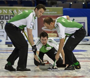 Larry Wong/Edmonton Journal
Saskatchewan skip Brock Virtue delivers a rock as teammates DJ Kidby, left, and Chris Schille sweep during Saturday afternoon's game against Prince Edward Island's Eddie MacKenzie in the Tim Horton's Brier at Rexall Place.
