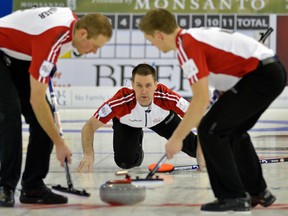 Team Newfoundland and Labrador skip Brad Gushue delivers a rock between sweepers Geoff Walker (lead) and Adam Casey (second) during game action against Team Saskatchewan at the 2013 Tim Hortons Brier in Edmonton on Sunday March 3, 2013. Photo by Larry Wong/Edmonton Journal
