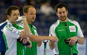 Team Saskatchewan skip Brock Virtue (right) is congratulated by Chris Schille (middle/second) after Virtue made his last shot on the third end to score two points during a game against Northern Ontario in the morning draw at the 2013 Tim Hortons Brier in Edmonton on Thursday March 7, 2013. DJ Kidby (left/lead) is also in photo. Photo by Larry Wong, Edmonton Journal