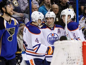 Edmonton Oilers' Jordan Eberle (14) celebrates with Taylor Hall (4) and Ryan Nugent-Hopkins (93) after scoring a goal as St. Louis Blues' Alex Pietrangelo (27) reacts in the first period of an NHL hockey game, Tuesday, March 26, 2013, in St. Louis. (AP Photo/Tom Gannam)