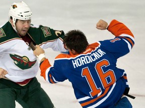 Minnesota Wild enforcer fights Edmonton Oilers tough guy Darcy Hordichuk in a September 2011 preseason game.