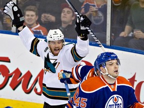 San Jose Sharks winger Martin Havlat, left, celebrates Joe Pavelski's goal (not shown) as Edmonton Oilers defenceman Mark Fistric skates past during first period NHL hockey action in Edmonton on Wednesday, March 20, 2013. Photo by Jason Franson, The Canadian Press