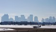Haze blurs the city skyline in this photo from the city centre airport. Photo by Ed Kaiser, Edmonton Journal.