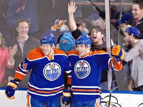 Edmonton Oilers' Corey Potter, 44, and Taylor Hall celebrate Hall's goal against the Vancouver Canucks during first period NHL hockey action in Edmonton, Alta., on Saturday March 30, 2013. THE CANADIAN PRESS/Jason Franson.