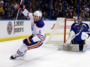 Edmonton Oilers defenceman Ryan Whitney, left, celebrates after scoring on St. Louis Blues goalie Jaroslav Halak on March 1, 2013, in St. Louis. Photo by Jeff Roberson, Associated Press