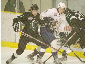 Mike Williamson of the Spruce Grove Saints, tries to break through Josh Healey and Bowen Croft of the Sherwood Park Crusaders of the Alberta Junior Hockey League playing at Grant Fuhr Arena in Spruce Grove. Photo by Shaughn Butts, Edmonton Journal