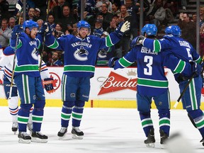 Vancouver Canucks skaters celebrate one of their goals in a 4-0 win over Edmonton on Thursday night, (Photo: Jeff Vinnick/Getty Images)