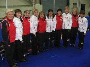 Canada's Cathy King rink poses for a picture with Veronika Huber's team from Austria on Thursday at the world senior women's curling championship in Fredericton, N.B.
