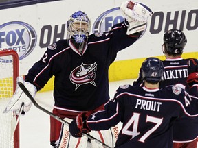 Columbus Blue Jackets goalie Sergei Bobrovsky, left, celebrates his shutout win over the San Jose Sharks with teammates Dalton Prout and Nikita Nikitin on Tuesday, April 9, 2013, in Columbus. Photo by Jay LaPrete, Associated Press