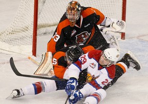 Mitchell Moroz of the Edmonton oil Kings and Tyler Lewington of the Medicine Hat Tigers slide in front of goalie Cam Lanigan in Game 2 of their WHL playoff series April 7, 2013. Photo by Greg Southam, Edmonton Journal