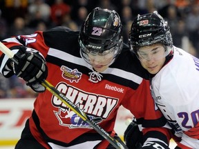 Sean Monahan (#20 on right) battles for position with Frederik Gauthier during the 2013 CHL Top Prospects game. (Photo: Getty Images)