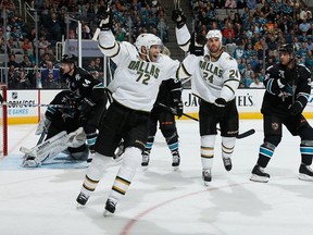 Dallas Stars forwards Erik Cole, second from left, and Eric Nystrom, third from left, celebrate a goal as San Jose Sharks' Marc-Edouard Vlasic and Adam Burish look on during their game on April 7, 2013 in San Jose, Calif. The Stars won the game 5-4 in a shootout, moving them into 10th place in the NHl Western Conference standings. Photo by Don Smith, NHLI via Getty Images