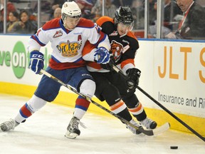 Edmonton Oil Kings defenceman Keegan Lowe, left, tries to knock Medicine Hat Tigers centre Dylan Bredo off the puck during Game 1 of their WHL second-round playoff series at Rexall Place in Edmonton on Friday, April 5, 2013. Photo by Shaughn Butts, Edmonton Journal