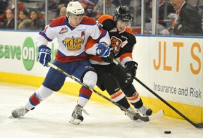 Edmonton Oil Kings defenceman Keegan Lowe, left, tries to knock Medicine Hat Tigers centre Dylan Bredo off the puck during Game 1 of their WHL second-round playoff series at Rexall Place in Edmonton on Friday, April 5, 2013. Photo by Shaughn Butts, Edmonton Journal