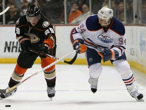 Anaheim Ducks' Matt Beleskey lifts the stick of Edmonton Oilers forward Ryan Smyth during their game at Anaheim's Honda Center on April 8, 2013.  Photo by Victor Decolongon, Getty Images