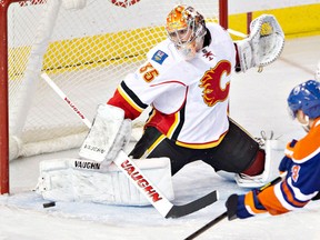 Calgary Flames goalie Joey MacDonald stops a shot by Edmonton Oilers forward Taylor Hall during their game Saturday, April 13, 2013, at Rexall Place. The Flames won 4-1. Photo by Jason Franson, The Canadian Press