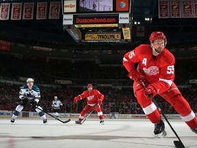Detroit Red Wings defenceman Niklas Kronwall, right, carries the puck as teammate Patrick Eaves, centre, shadows San Jose Sharks forward Logan Couture, left, during their game Thursday, April 11, 2013, at Detroit's Joe Louis Arena. Photo by Dave Reginek, Getty Images