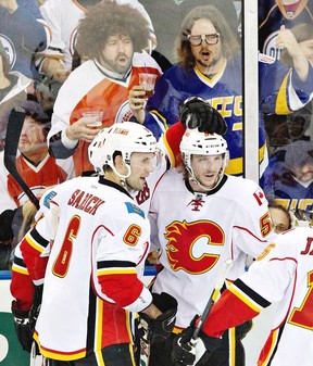 Calgary Flames Cory Sarich #6 and Maxwell Reinhart #59 celebrate a goal against the Edmonton Oilers during third period NHL hockey action in Edmonton, Alta., on Saturday April 13, 2013. THE CANADIAN PRESS/Jason Franson.
