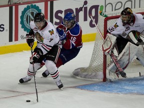 PORTLAND, OREGON -May 12, 2012 - Winterhawks #7 Joseph Morrow brings the puck around the net away from Edmonton's #16 T. J. Foster as Mac Carruth watches.  The first period ended with the Portland Winterhawks even 1-1 with the Edmonton Oil Kings in game 6 of the Western Hockey League Championship playoffs at the Rose Garden.       Doug Beghtel/ The Oregonian