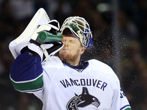 Goaltender Cory Schneider of the Vancouver Canucks sprays water iin Game 4 of his team's playoff series against the San Jose Sharks on May 7, 2013. The Sharks defeated the Canucks 4-3 to sweep the series 4 games to 0. Photo by Christian Petersen, Getty Images