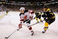 New Jersey Devils' David Clarkson takes the puck into the corner with Milan Lucic hot on his heels. (Photo: Jared Wickerham/Getty Images)