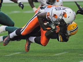 Edmonton Eskimos defender Rod Davis takes down B.C. Lions receiver Masnny Arceneaux in a July 2010 game. Edmonton Journal file photo